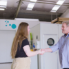 Woman and man shaking hand in business setting