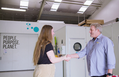 Woman and man shaking hand in business setting